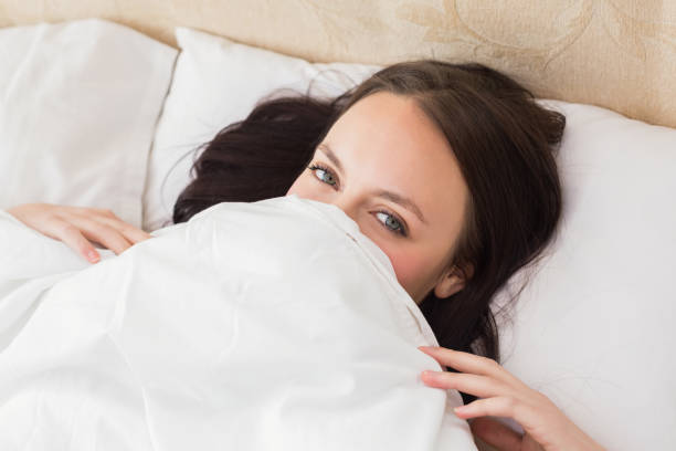 istock Pretty brunette under the duvet 824060492