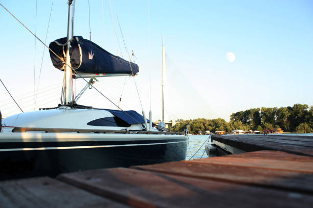 istock Small sailboat docking at the marina at sunset 824064688