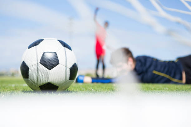 istock Goalkeeper lying on field while playing soccer 824065856