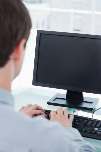 istock Back view of a businessman using a monitor 824071396