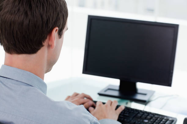 istock Back view of a businessman working with a computer 824071436
