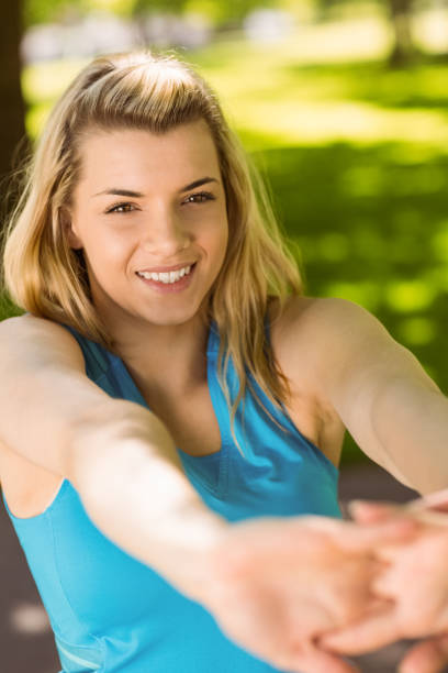 istock Fit blonde stretching in the park 824071602
