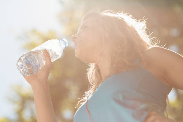 istock Fit blonde drinking from her water bottle 824071856