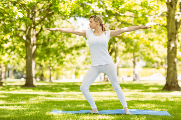 istock Peaceful blonde doing yoga in the park 824074494