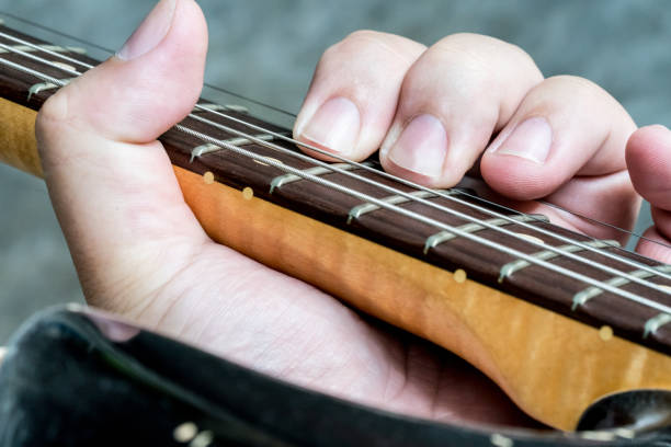 istock closeup on guitarist hand playing his vintage guitar 824087236
