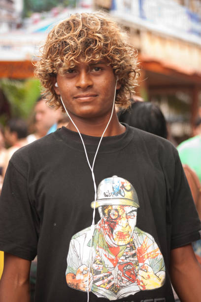 Montanita Portrait Montañita, Santa Elena, Ecuador - February 5, 2012: Portrait of a tourist man walking at at the principal street on Montañita, Ecuador. Background some tiki stores. montanita ecuador stock pictures, royalty-free photos & images