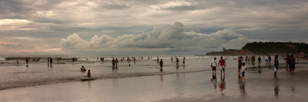 Montanita Mountaineer Ecuador Montañita Montanita, Santa Elena, Ecuador - February 4, 2012: People walking to the ocean to take a picture of the sunset in the Pacific Ocean. montanita ecuador stock pictures, royalty-free photos & images