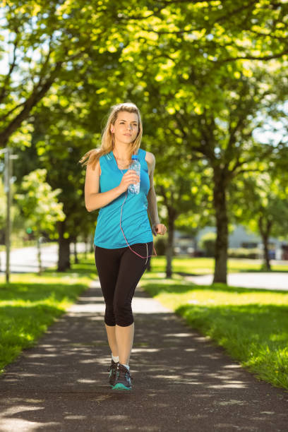 istock Fit blonde jogging in the park 824108976
