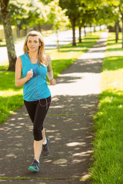 istock Fit blonde jogging in the park 824109002