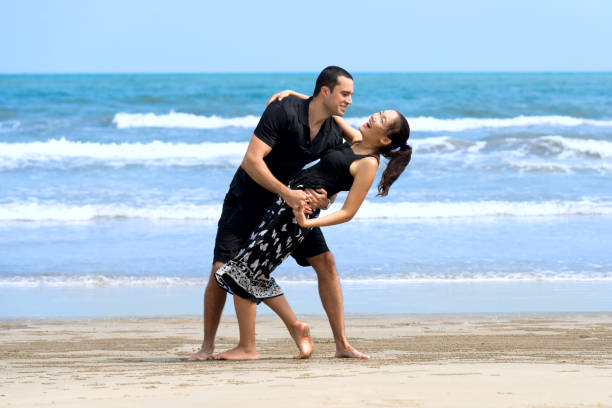 istock Happy romantic interracial  couple enjoying on beach 824110882