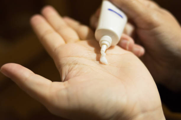 istock close up hand girl using cosmetic cream 824112580