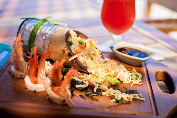 istock Rice with seafood decorated with prawns in bamboo on cutting board 824115800