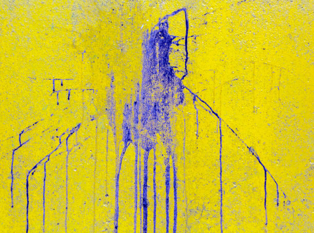istock blue paint spot on yellow cement wall 824116884
