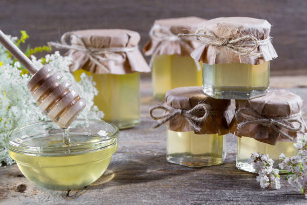 istock Group of glass jars with honey on  a rustic  background 824123316