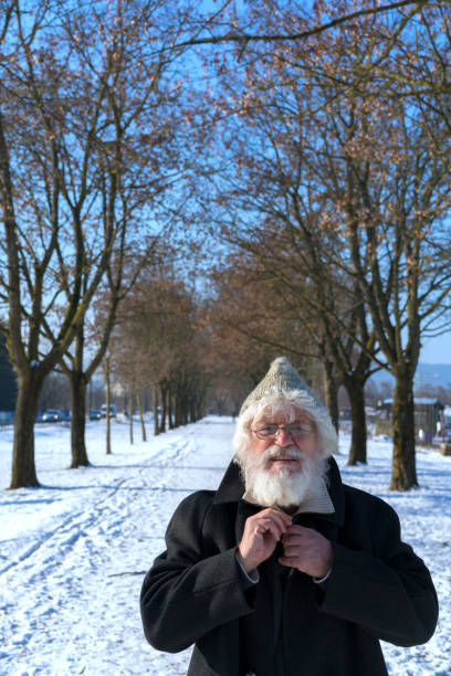 istock Senior with white beard, skiing cap glasses in PST Park 824125870