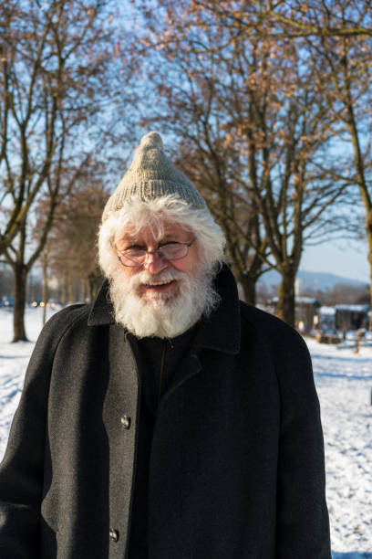istock Senior with white beard, skiing cap glasses in PST Park 824125904