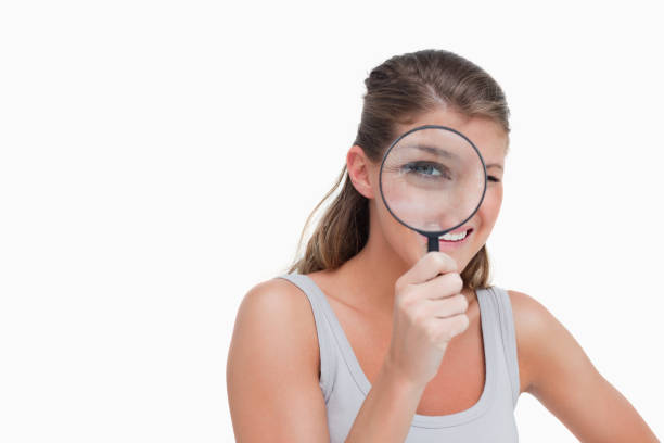 istock Woman looking through a magnifying glass 824126788