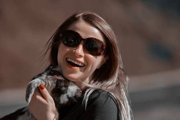 istock smiling woman embracing billy goat 824129350