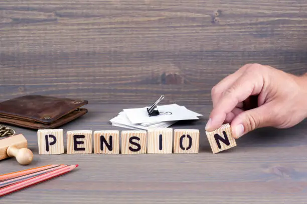 Photo of pension. Wooden letters on dark background