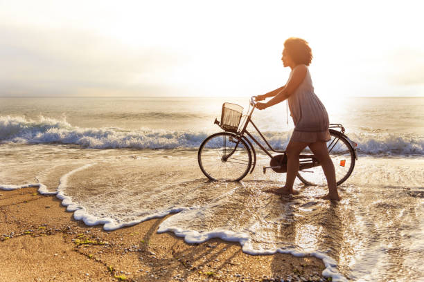 Young woman riding on beach at sunset.