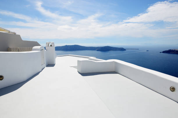 Two chairs on the terrace with sea view. White architecture on Santorini island, Greece.