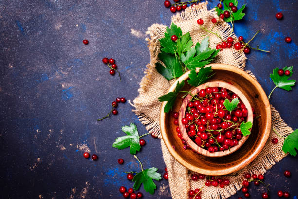 istock Red currant in a bowl on a canvas napkin, rustic style, food background, top view 824142786