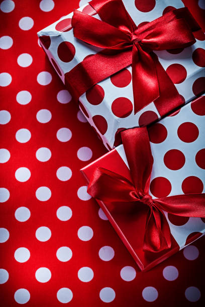 istock Christmas presents on polka-dot red textile holidays concept 824143040