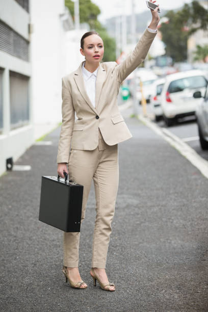 istock Young businesswoman hailing a cab 824163606