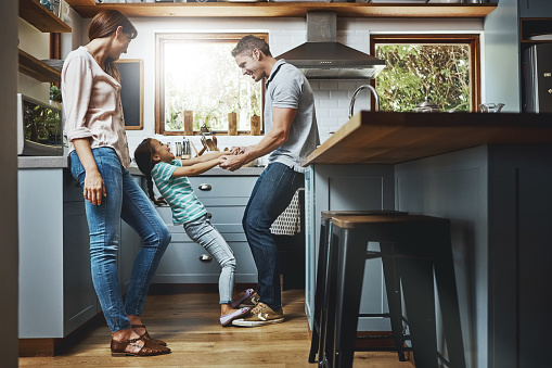 Shot of a family playing together in the kitchen at home