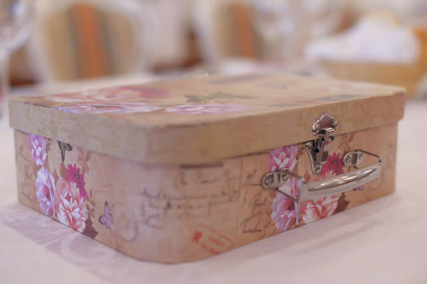 Ornate keepsake box for gifts keeping at a weeding ceremony Horizontal shot of intricate rounded corner box, a typical money, gifts and memories gatherer at a wedding ceremony. Vintage box in pastel colors with floral print. souvenir stock pictures, royalty-free photos & images