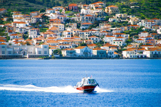Small red motor boat transfer people to Spetses island, Greece