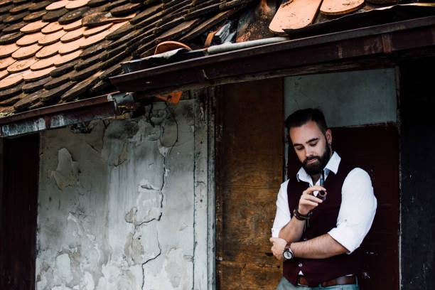 istock Bearded man smoking wooden pipe 824170700