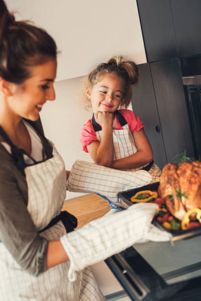 istock Mother taking the dinner out of the oven 824173718