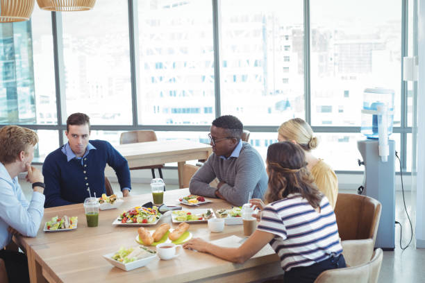 istock Business people having lunch at office cafeteria 824175936