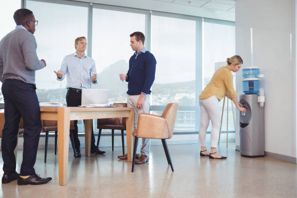 istock Business colleagues holding drinking glasses at office cafeteria 824175980