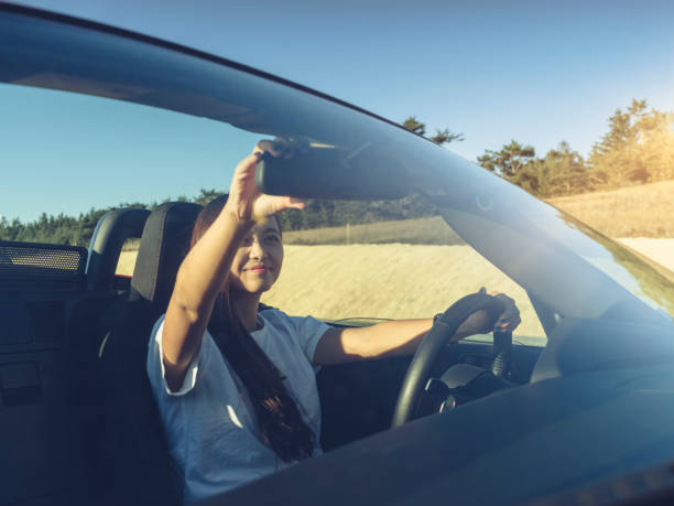 istock woman driving convertible at coast highway 824182008