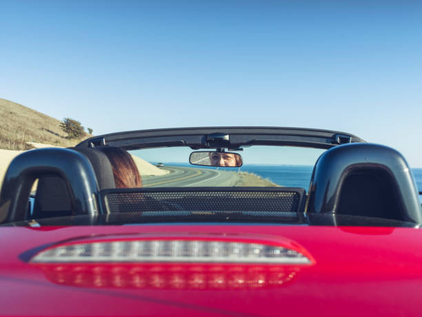 woman driving convertible at coast highway,san juan island,usa.