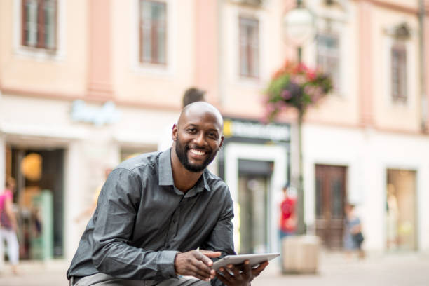 istock Businessman sitting on the bench and using digital tablet 824182800