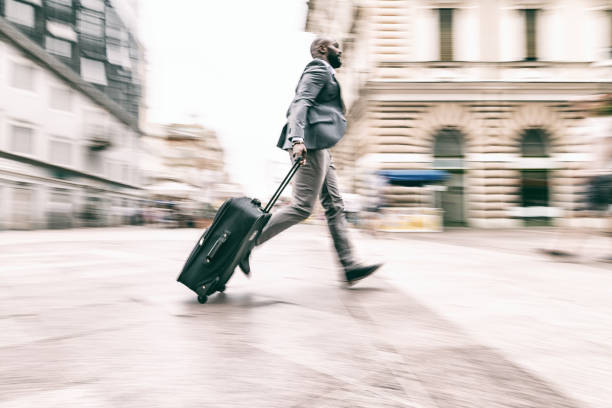 istock Businessman hurrying down the street with a suitcase 824182846