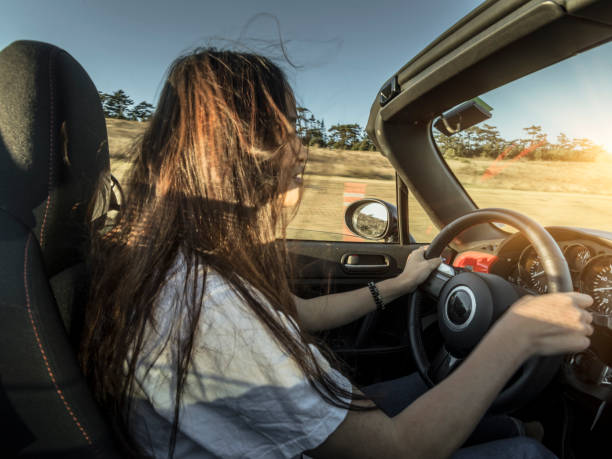 istock woman driving convertible at coast highway 824186420