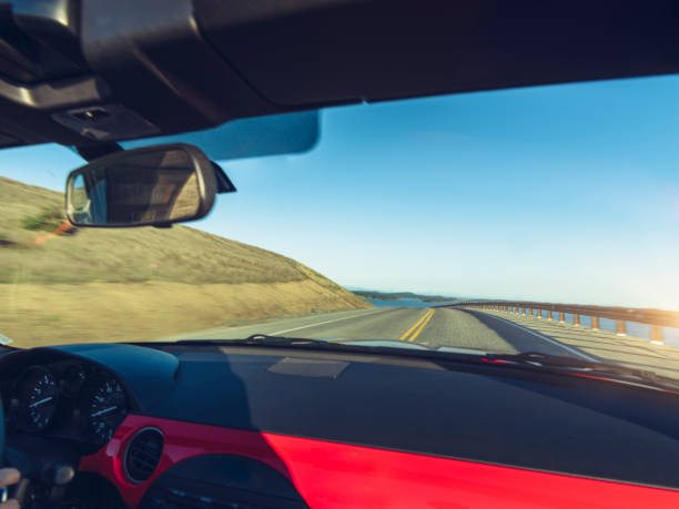 istock woman driving convertible at coast highway 824186668