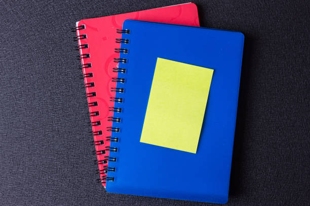 istock Blue and red notepads on a spiral with a sticker 824190746