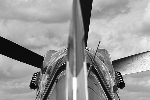 Black and white picture of a Spitfire, taken from behind with a long focal lens, outlining propeller and exhaust pipes.