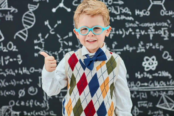 istock Smart boy in front of black board 824197884