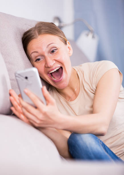 istock Woman with phone on sofa 824197888