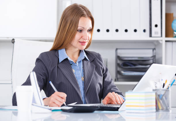 istock Smiling woman working in office 824198212