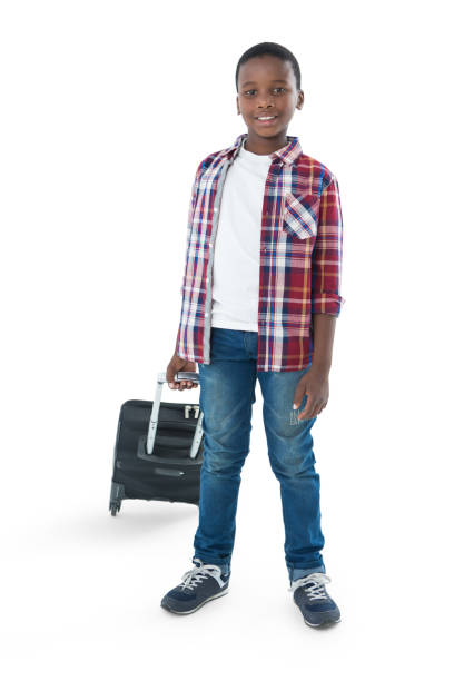 istock Portrait of smiling boy standing with suitcase 824198430