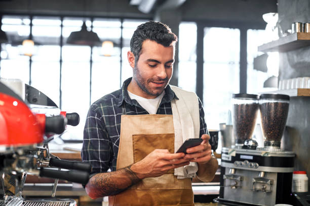 istock Barista talking with phone in cafe. 824198494