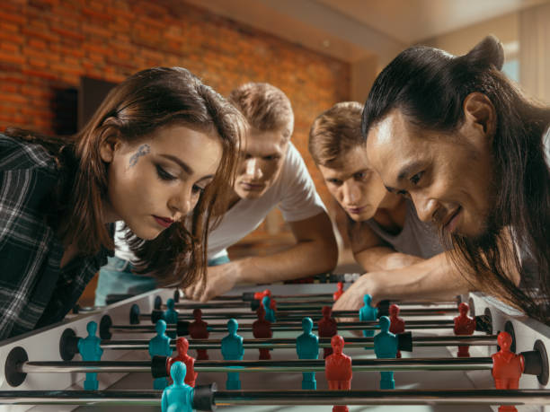 istock Friends are getting ready to play table football/kicker game 824200784