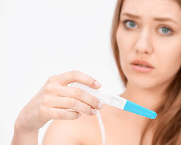 istock worried woman holding pregnancy test 824200920